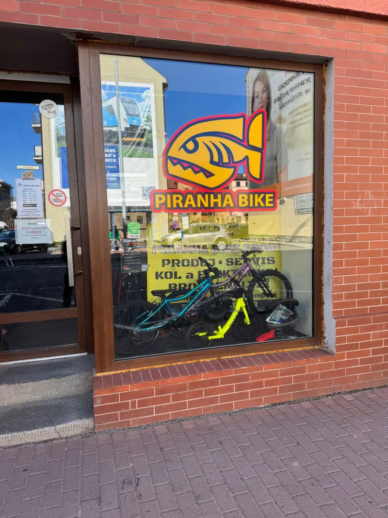 Výloha s logem piraně a nápisem Piranha Bike na ulici M. R. Štefánika